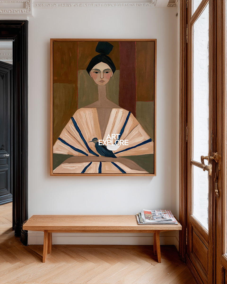 A framed art print depicting a stylized woman in a fan dress with a bird, hung on a white wall above a wooden bench in a bright room with herringbone wood floors.